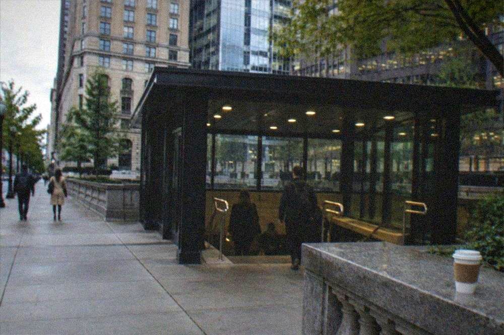Subway station entrance sign on a downtown Boston sidewalk