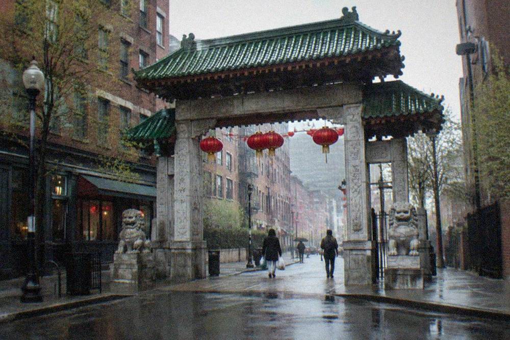 Chinatown gateway arch above a busy street with restaurant signs