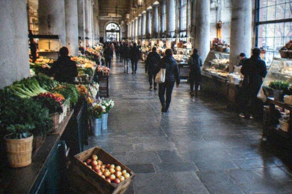 Long market hall interior with food stalls and counters under high ceilings