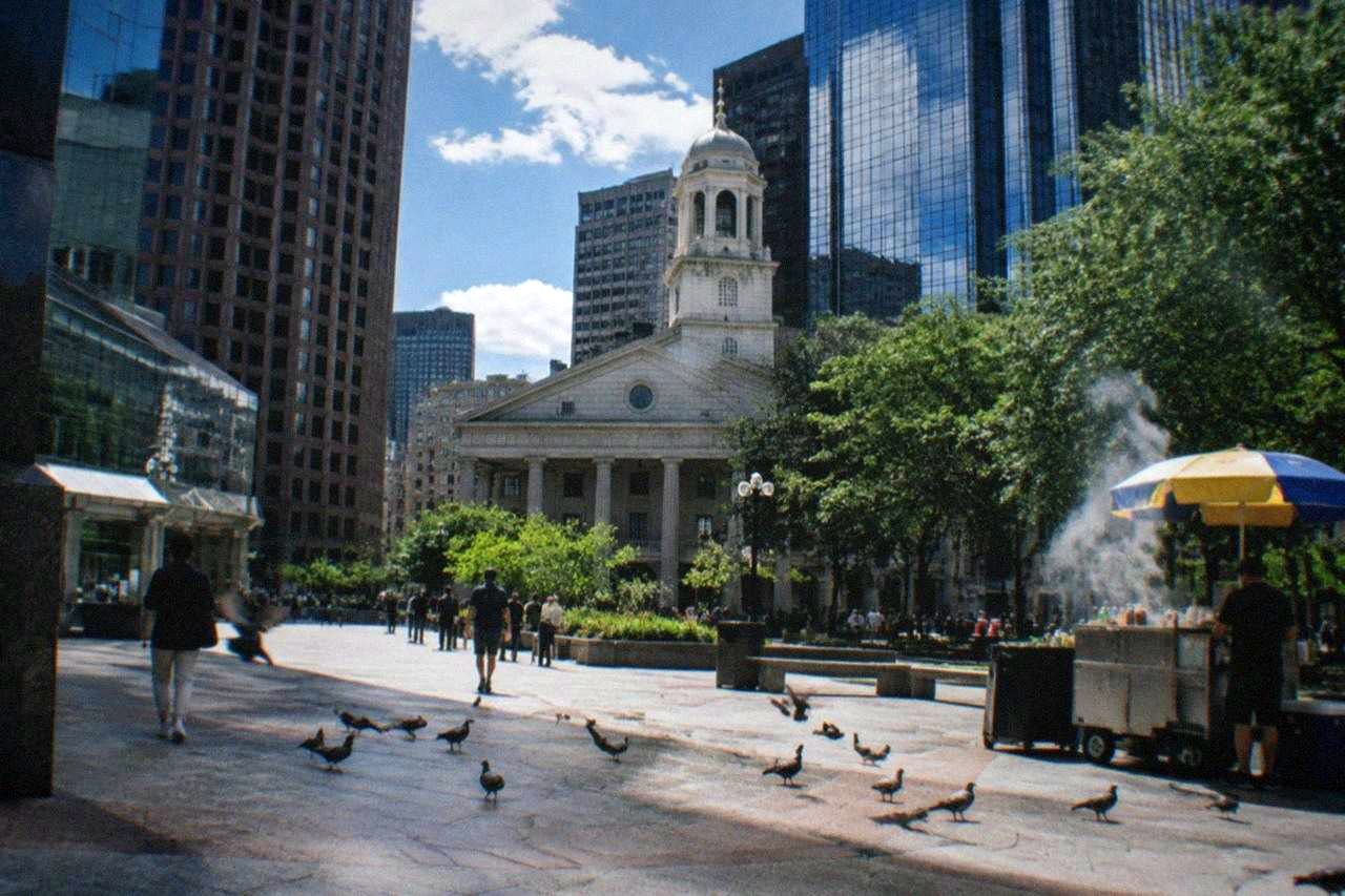Historic market buildings around a cobblestone plaza in downtown Boston with a columned hall at one end