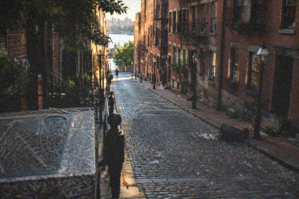 Empty narrow North End street with brick buildings in early morning light