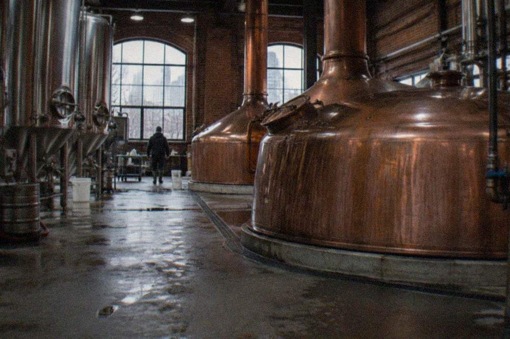 Brewing kettles and steel tanks on the floor of the Samuel Adams Boston Brewery