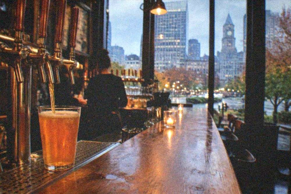 Bartender pouring a craft beer at a brewery taproom counter