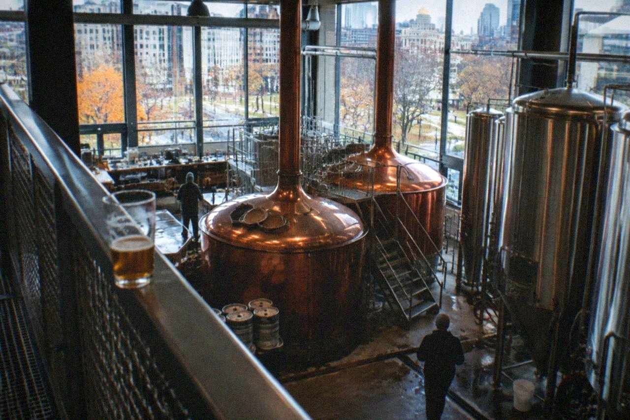 Copper brewing kettles and stainless steel tanks inside a craft brewery