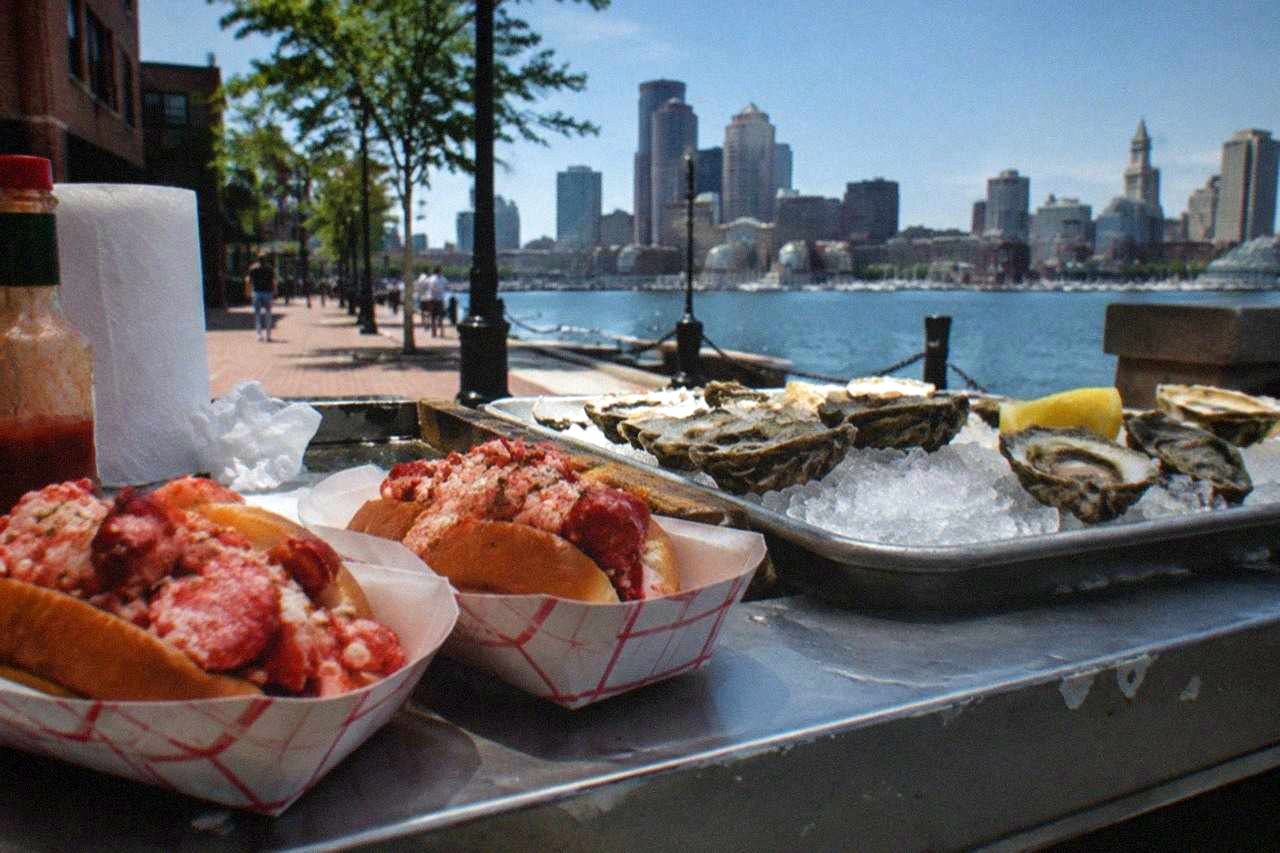 Fresh lobster rolls and oysters on ice at a Boston seafood counter