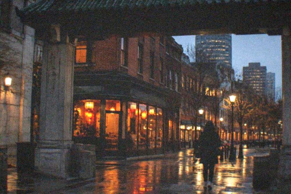 Entrance arch and street signs marking the edge of a Chinatown dining district