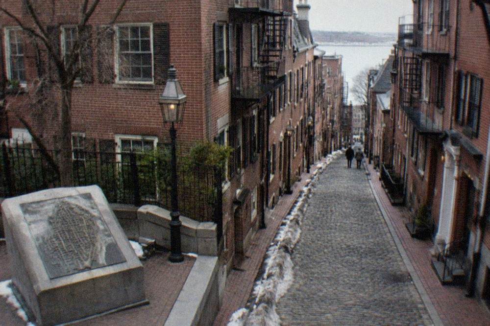 Old brick rowhouses and a narrow cobblestone lane in the historic North End
