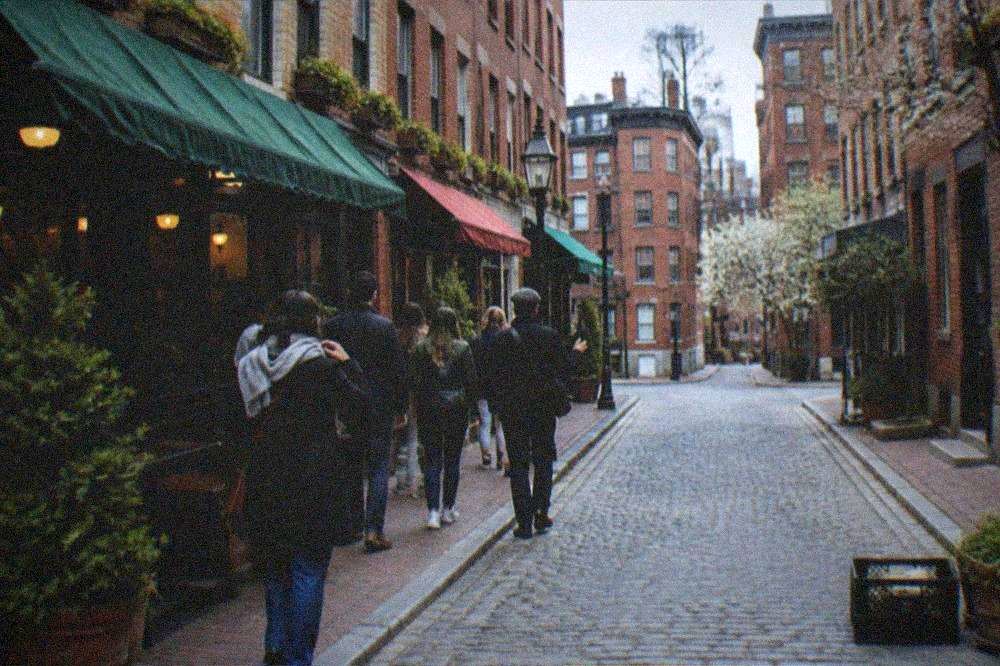 Small group of visitors walking with a guide past North End storefronts