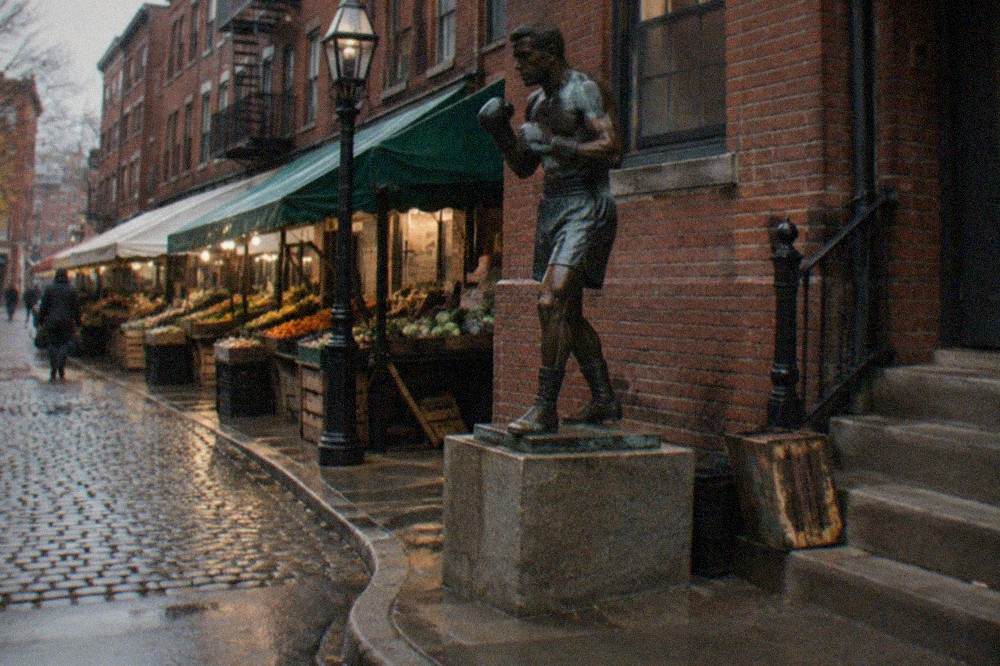 A narrow North End street with brick buildings and Italian market awnings