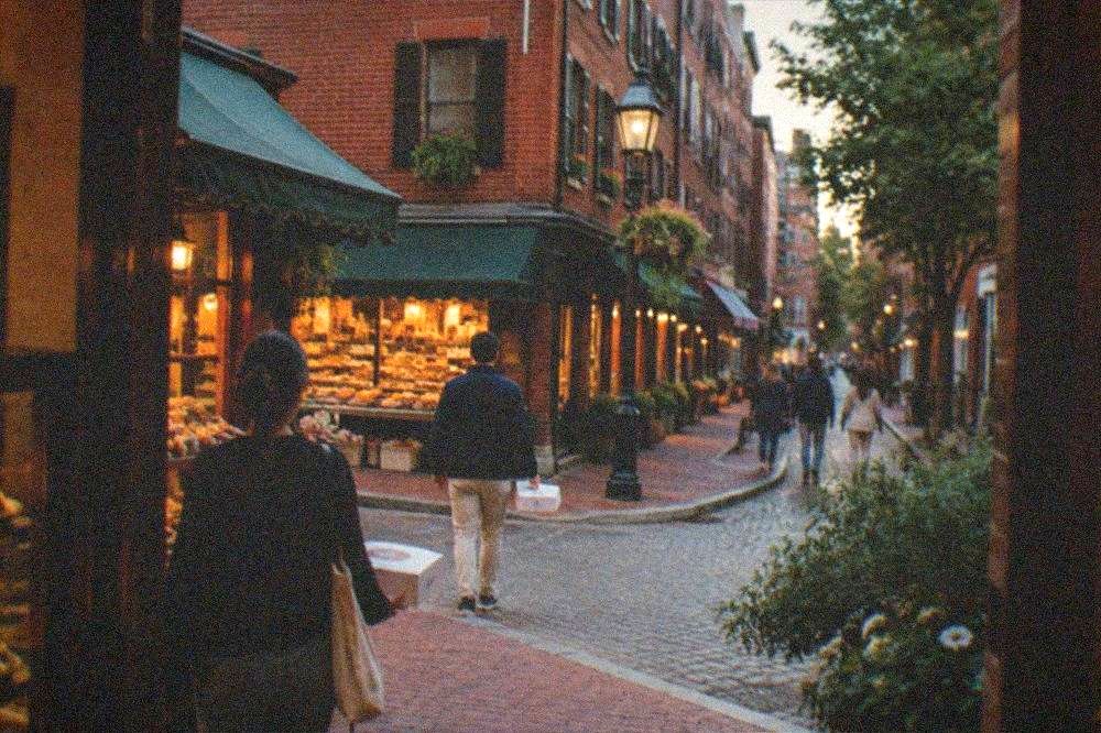 Narrow old city street with Italian bakery storefronts and awnings